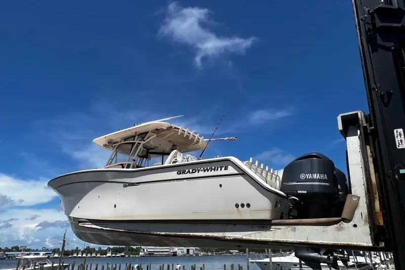  Yacht Photos Pics 2015 Grady-White Canyon 336 boat with Yamaha engine on lift under blue sky.