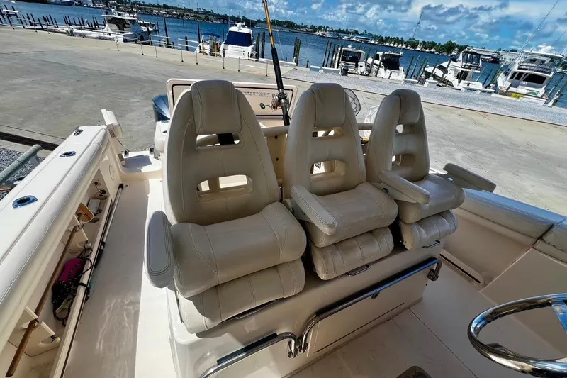  Yacht Photos Pics 2015 Grady-White Canyon 336 boat interior with three cushioned seats, docked by the marina.