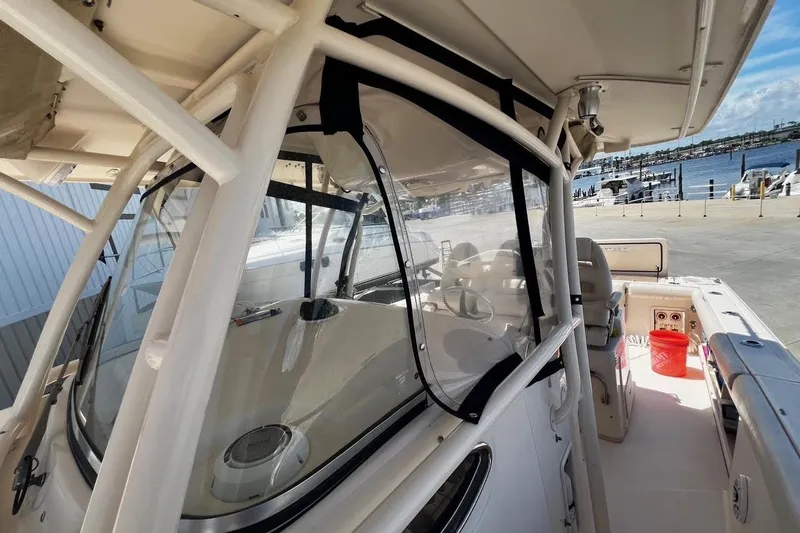  Yacht Photos Pics 2015 Grady-White Canyon 336 boat interior with clear enclosure, dockside view.