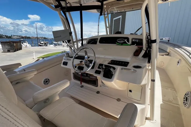  Yacht Photos Pics 2015 Grady-White Canyon 336 boat cockpit with steering wheel and navigation equipment.