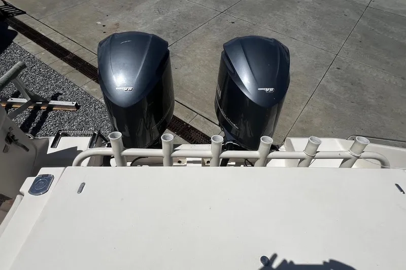  Yacht Photos Pics 2015 Grady-White Canyon 336 boat with dual outboard engines, docked on concrete.