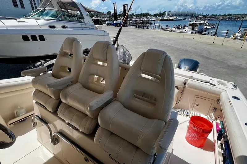  Yacht Photos Pics 2015 Grady-White Canyon 336 boat interior with three cushioned seats at the dock.