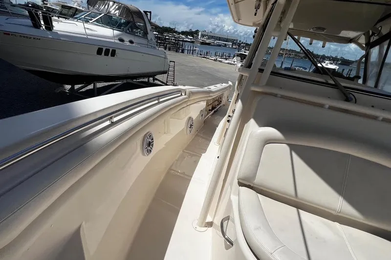  Yacht Photos Pics 2015 Grady-White Canyon 336 boat interior with seating, docked near other vessels.