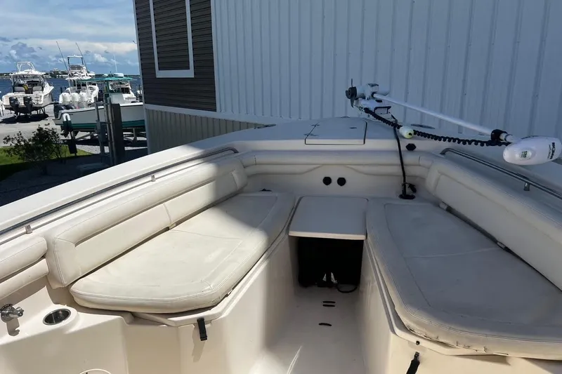  Yacht Photos Pics 2015 Grady-White Canyon 336 boat interior with cushioned seating and fishing equipment.