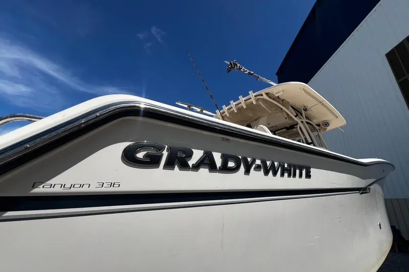  Yacht Photos Pics 2015 Grady-White Canyon 336 boat with sleek design under clear blue sky.