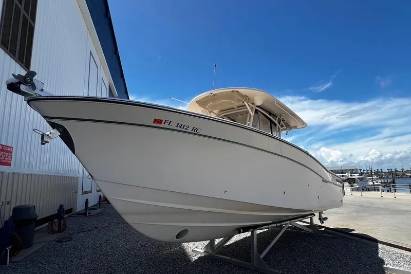  Yacht Photos Pics 2015 Grady-White Canyon 336 boat on dry dock under clear blue sky.