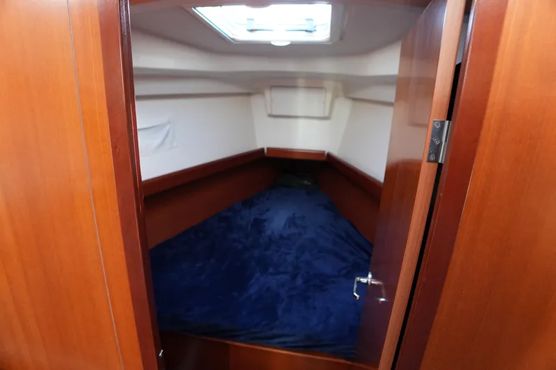 Andiamo! Yacht Photos Pics Cozy cabin interior of 2007 Beneteau 373 sailboat with wooden finish and skylight.