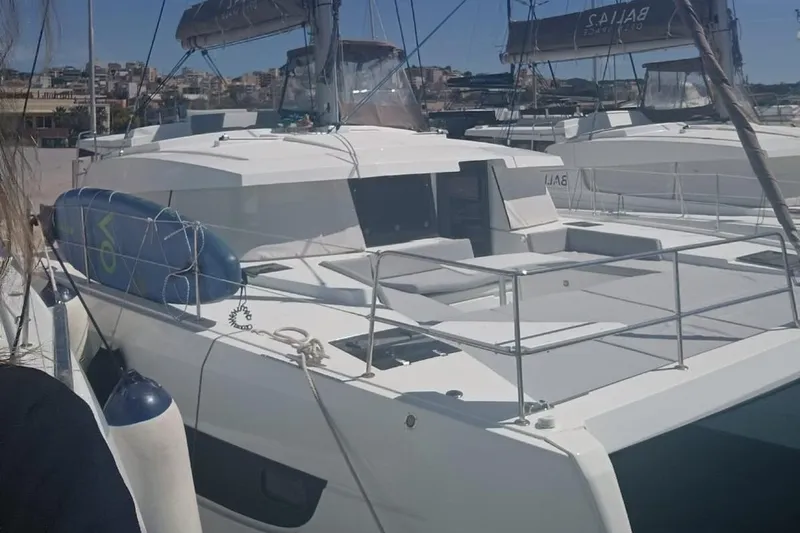 High School Yacht Photos Pics 2023 Bali 4.2 catamaran docked at marina, featuring spacious deck and modern design.