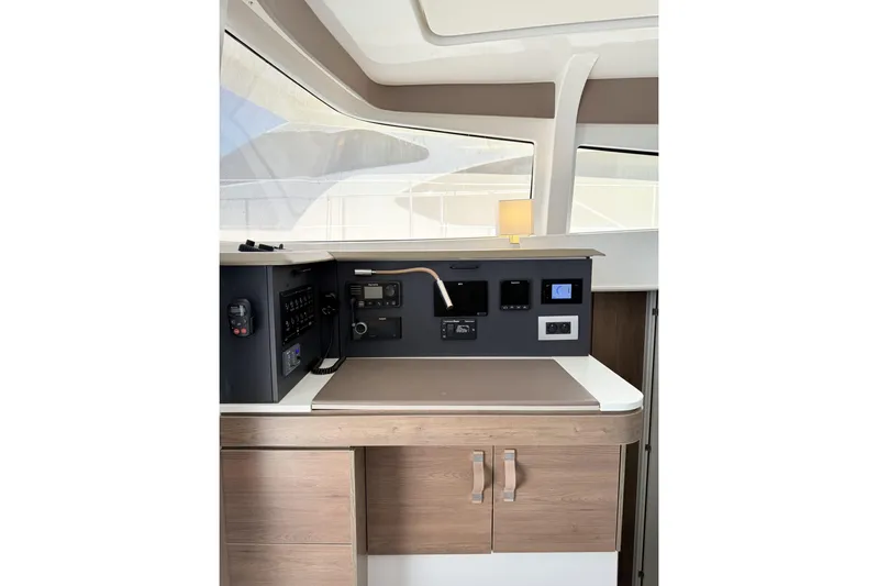 High School Yacht Photos Pics Interior of 2023 Bali 4.2 yacht with modern control panel and wooden cabinetry.