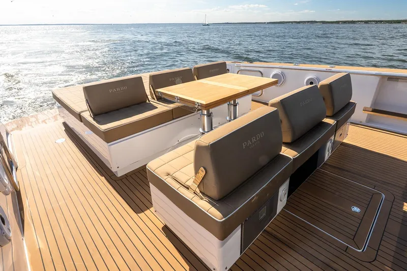  Yacht Photos Pics Luxury seating area on 2023 Pardo Yachts 43, featuring elegant wood deck and ocean view.