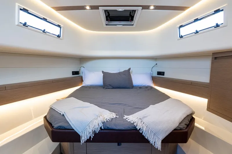  Yacht Photos Pics Luxurious cabin interior of 2023 Pardo Yachts 43, featuring a cozy bed and modern lighting.
