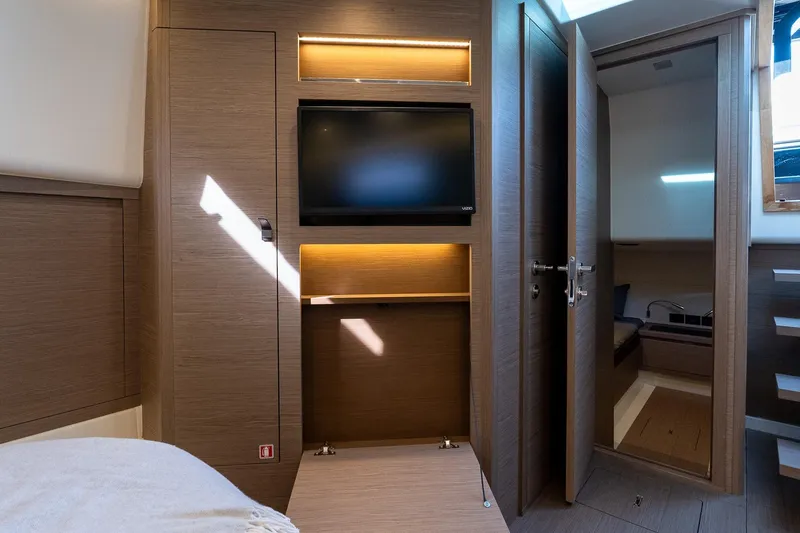  Yacht Photos Pics Interior of 2023 Pardo Yachts 43, featuring a modern cabin with TV and wooden finishes.