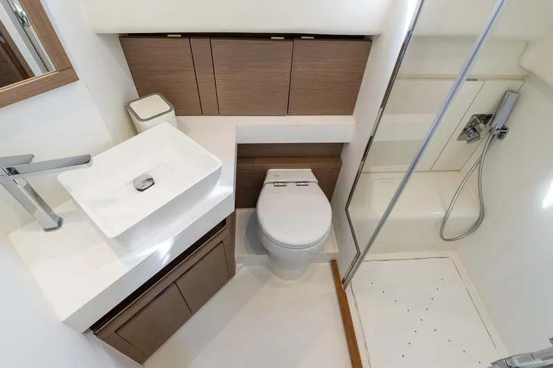  Yacht Photos Pics Modern bathroom in 2023 Pardo Yachts 43, featuring sleek sink, toilet, and shower.
