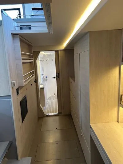 About Time Yacht Photos Pics Modern interior of 2021 Leopard 45 yacht with sleek wooden cabinetry and ambient lighting.