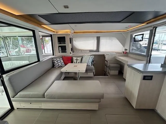About Time Yacht Photos Pics Luxurious interior of a 2021 Leopard 45 catamaran with modern seating and dining area.