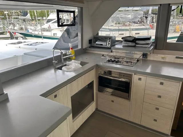 About Time Yacht Photos Pics Modern kitchen interior on a 2021 Leopard 45 yacht, featuring sleek countertops and appliances.