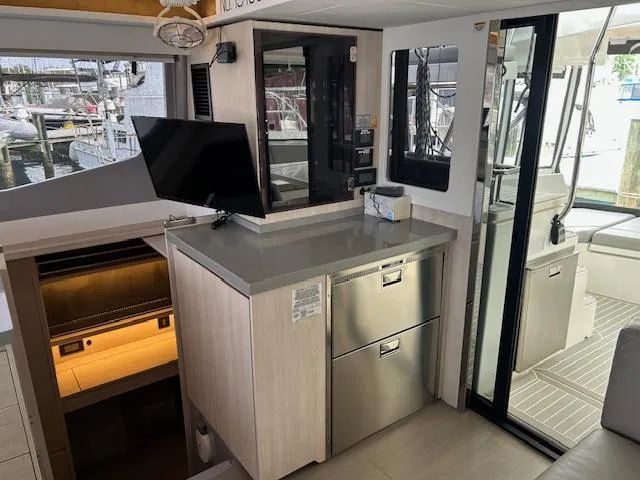 About Time Yacht Photos Pics Modern interior of 2021 Leopard 45 yacht with sleek cabinetry and stainless steel appliances.