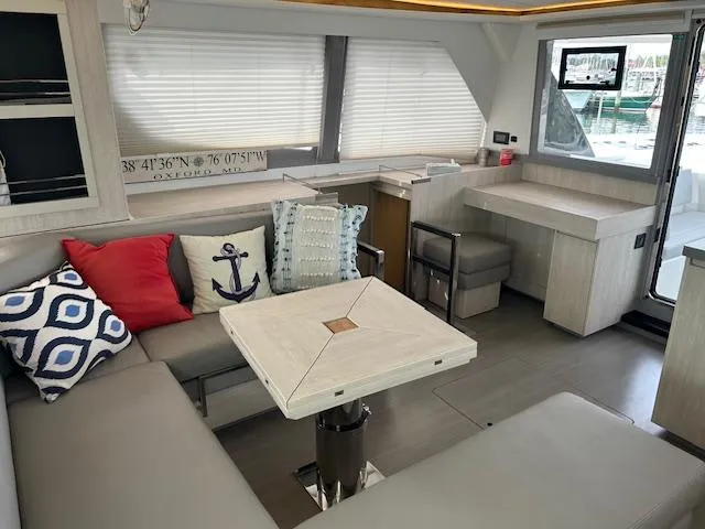 About Time Yacht Photos Pics Modern Leopard 45 yacht interior with cozy seating, nautical decor, and dining area, 2021 model.