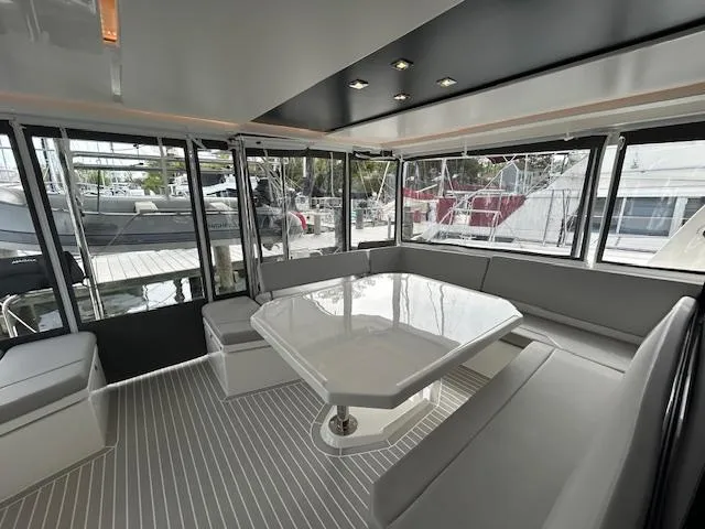 About Time Yacht Photos Pics Modern interior of 2021 Leopard 45 yacht with sleek seating and table.