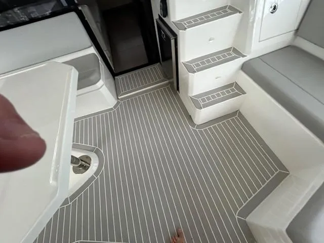 About Time Yacht Photos Pics Interior of 2021 Leopard 45 yacht with striped flooring and seating area.