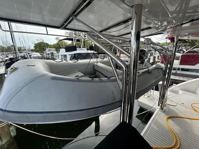 About Time Yacht Photos Pics Inflatable boat on Leopard 45 catamaran, 2021 model, docked at marina with solar panels.