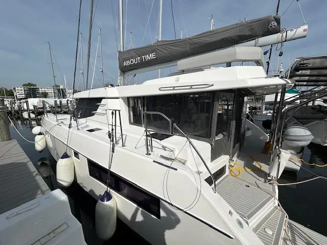 About Time Yacht Photos Pics 2021 Leopard 45 catamaran docked at marina, featuring sleek design and modern amenities.