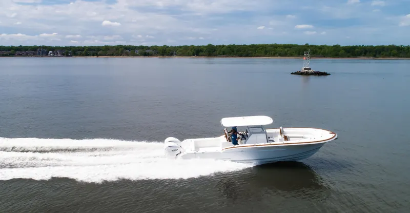  Yacht Photos Pics 2025 Buddy Davis 34 Center Console boat cruising on a calm lake.