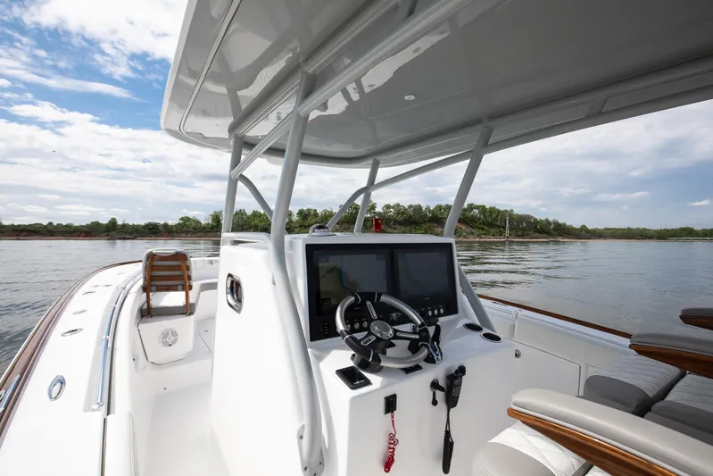  Yacht Photos Pics 2025 Buddy Davis 34 Center Console boat on calm water, featuring modern helm controls.