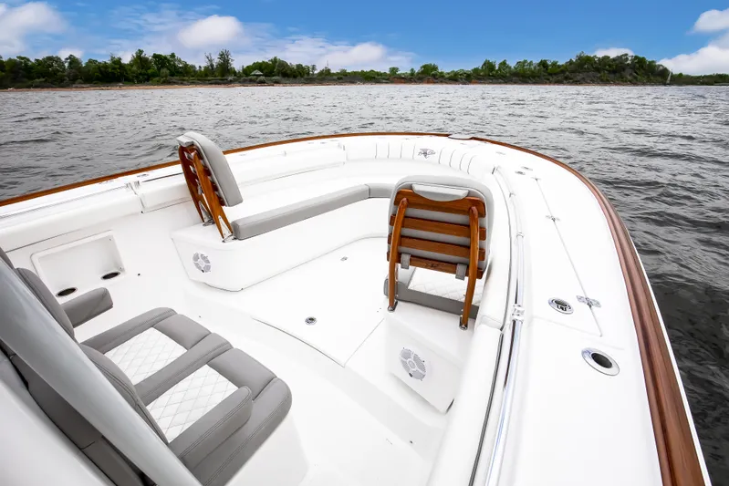  Yacht Photos Pics 2025 Buddy Davis 34 Center Console boat on calm waters, featuring sleek seating and design.