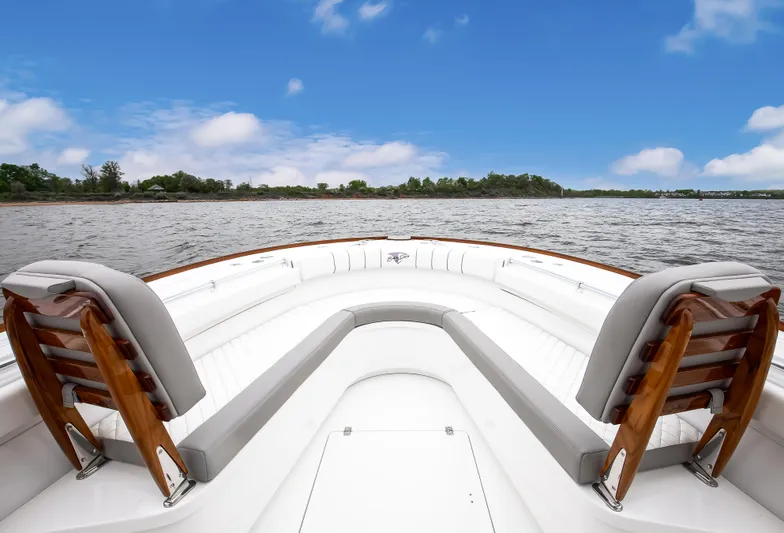  Yacht Photos Pics 2025 Buddy Davis 34 Center Console boat on calm water under blue sky.