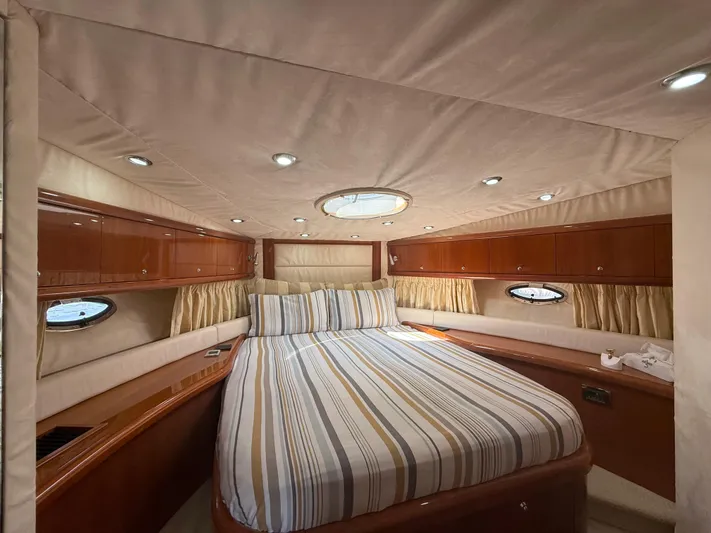  Yacht Photos Pics Luxurious cabin interior of 2006 Sunseeker Portofino 53 yacht with striped bedding.