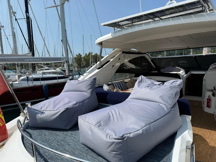  Yacht Photos Pics Luxury Sunseeker Portofino 53 yacht with comfortable deck seating, docked at marina.