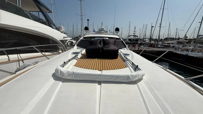  Yacht Photos Pics 2006 Sunseeker Portofino 53 yacht with teak deck, docked in a marina.