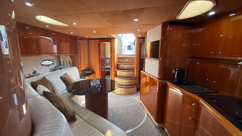  Yacht Photos Pics Luxurious interior of 2006 Sunseeker Portofino 53 yacht with elegant wood finishes.