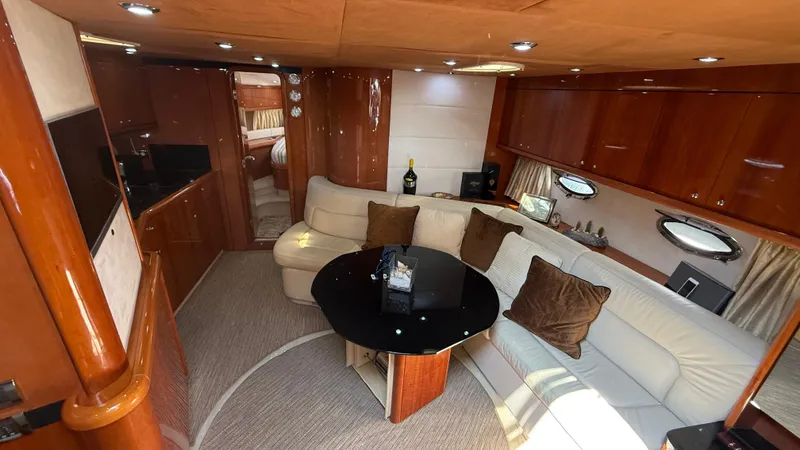  Yacht Photos Pics Luxurious interior of 2006 Sunseeker Portofino 53 yacht with elegant seating and wooden finishes.