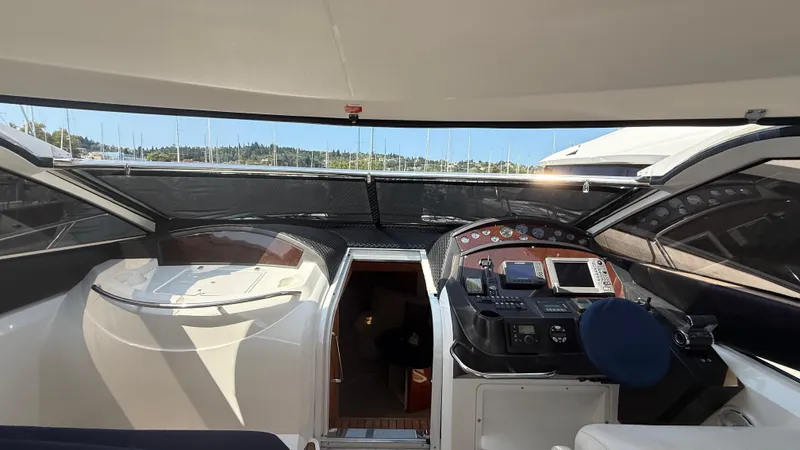  Yacht Photos Pics 2006 Sunseeker Portofino 53 yacht cockpit with navigation controls and seating.