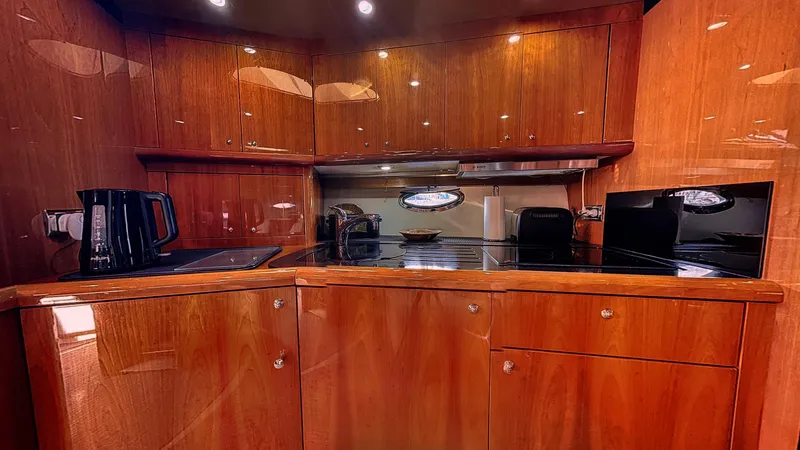  Yacht Photos Pics Luxurious wooden kitchen interior of 2006 Sunseeker Portofino 53 yacht.