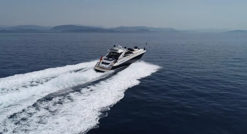  Yacht Photos Pics 2006 Sunseeker Portofino 53 yacht cruising on open sea, leaving a trail of white wake.