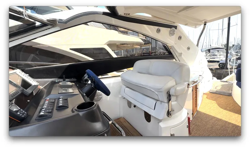  Yacht Photos Pics 2006 Sunseeker Portofino 53 yacht cockpit with modern controls and comfortable seating.