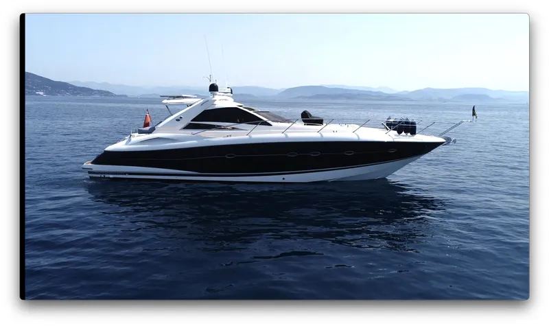  Yacht Photos Pics 2006 Sunseeker Portofino 53 yacht cruising on calm blue waters.