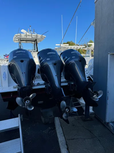  Yacht Photos Pics 2013 Contender 35 ST boat with triple outboard engines docked.