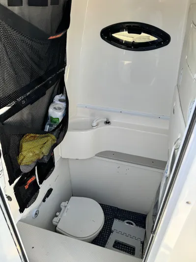  Yacht Photos Pics 2013 Contender 35 ST boat interior with compact bathroom and storage.