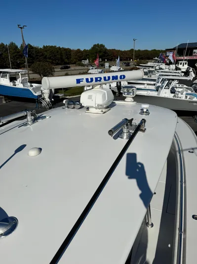  Yacht Photos Pics 2013 Contender 35 ST boat with Furuno radar, docked among other vessels.