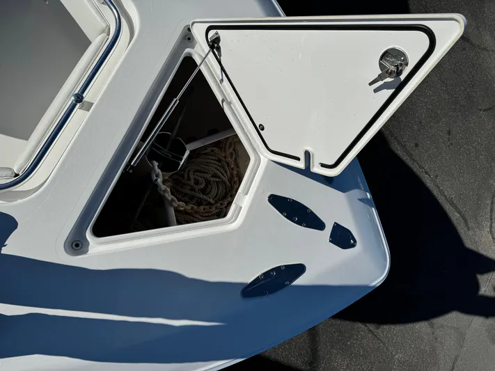 Yacht Photos Pics Open storage compartment on 2013 Contender 35 ST boat, showing rope and anchor.