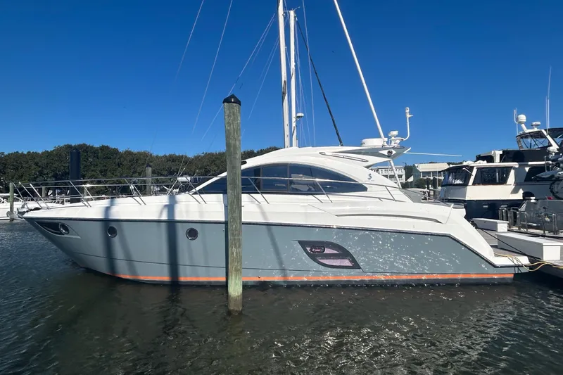  Yacht Photos Pics 2012 Beneteau Gran Turismo 44 yacht docked in marina under clear blue sky.
