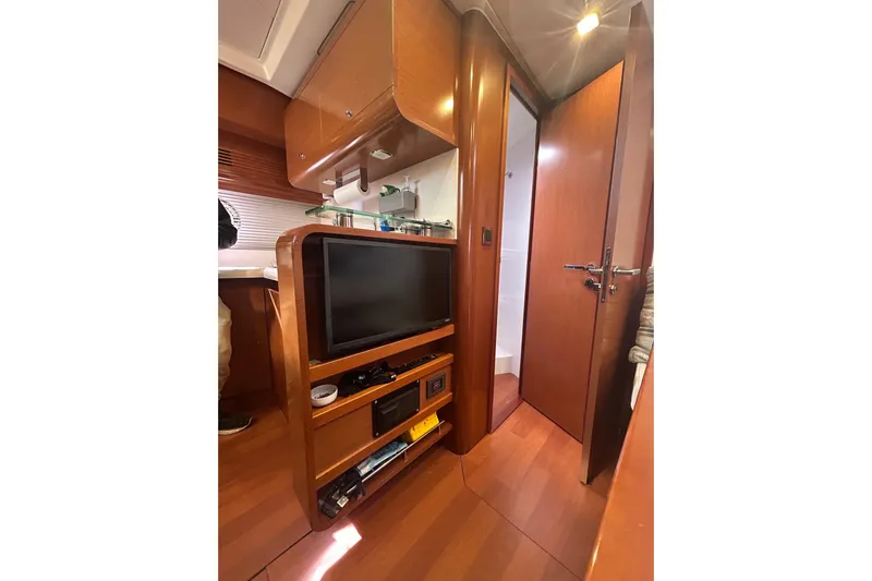  Yacht Photos Pics Interior of 2012 Beneteau Gran Turismo 44 yacht with TV and wooden cabinetry.