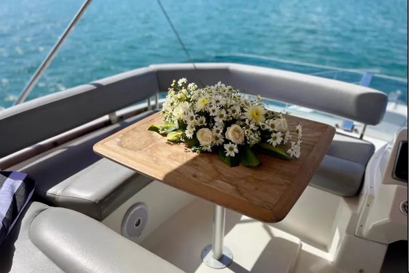  Yacht Photos Pics Luxurious 2013 Beneteau Antares 42 yacht interior with floral arrangement on wooden table.