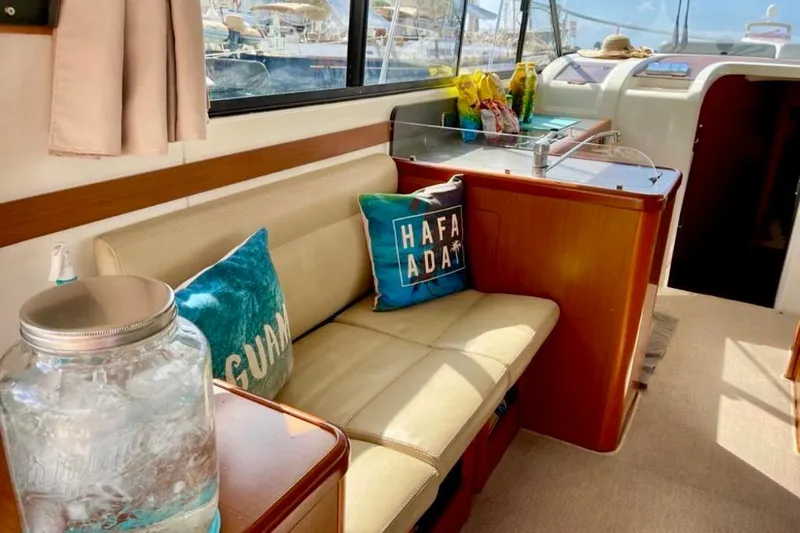  Yacht Photos Pics Interior of 2013 Beneteau Antares 42 yacht with cozy seating and nautical decor.