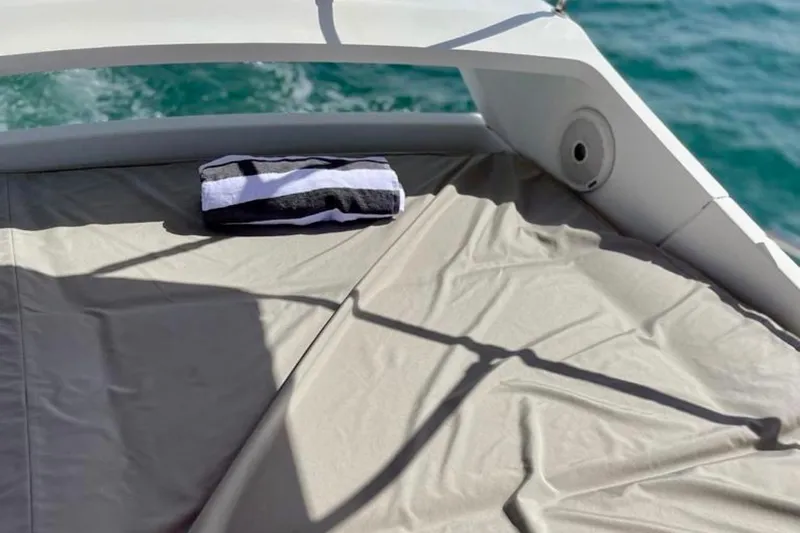 Yacht Photos Pics Sunbathing area on 2013 Beneteau Antares 42 yacht with towel, overlooking ocean.