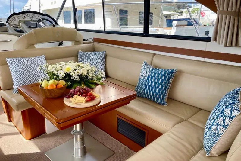  Yacht Photos Pics Luxurious interior of 2013 Beneteau Antares 42 yacht with elegant seating and dining area.